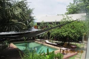 Hotel Esplanada outdoor pool with shade canopy and tropical garden