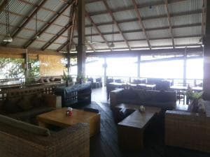 Hotel Esplanada beachfront bar lounge with rattan sofas under a thatched roof