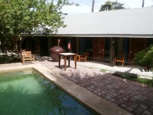 Hotel Esplanada pool deck with paved patio, garden tables and palm trees