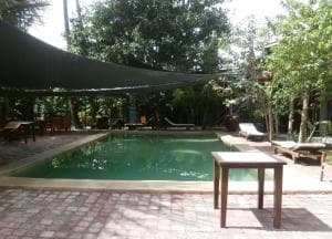 Hotel Esplanada pool with shade sail, garden setting and paved deck