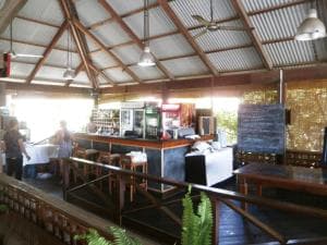 Hotel Esplanada open-air restaurant with red corrugated roof and bar counter