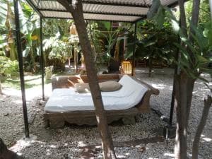 Hotel Esplanada garden with covered daybeds and cabanas under shaded foliage