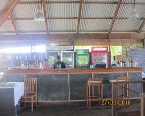 Hotel Esplanada outdoor bar with corrugated roof, wooden counter and stool seating