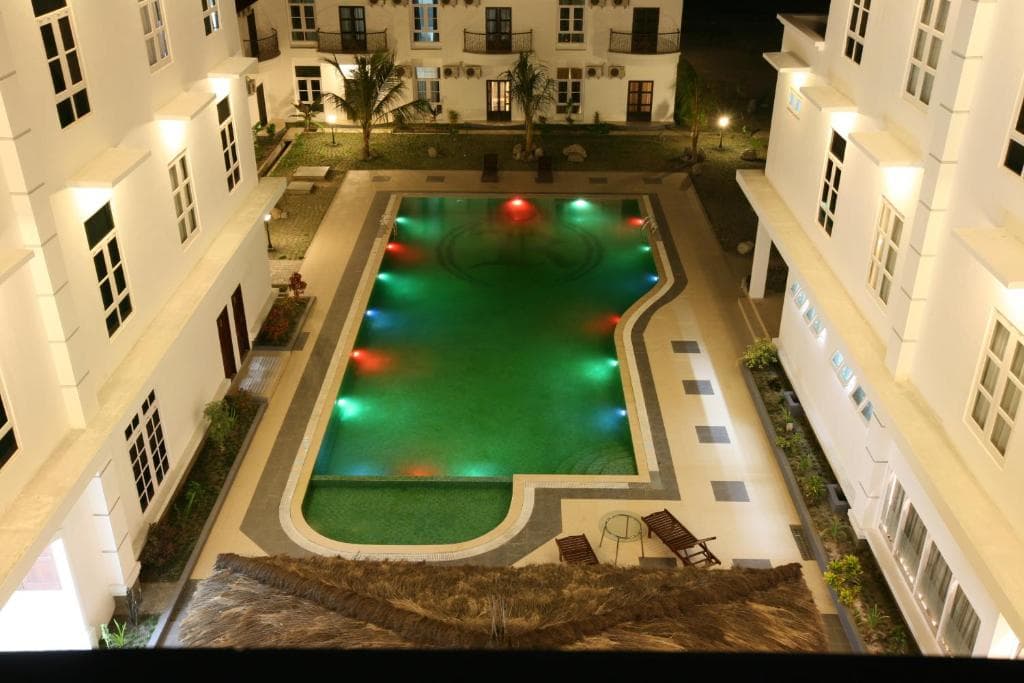 Hotel The Ramelau illuminated pool courtyard surrounded by the four-storey building