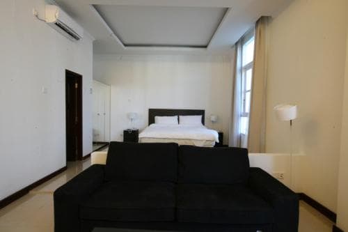 Hotel The Ramelau modern suite with king bed and small sofa