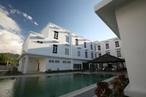 Hotel The Ramelau exterior with central pool and white-painted facade