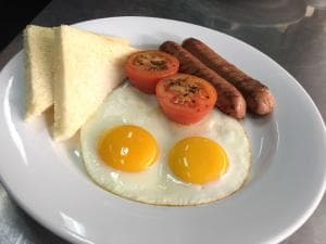 Hotel The Ramelau English breakfast plate with eggs, sausage, tomato and toast