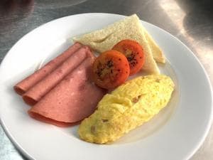 Hotel The Ramelau breakfast plate with omelette, ham and grilled tomato