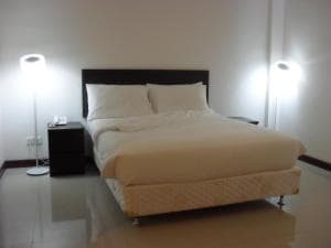 Hotel The Ramelau bedroom with king bed and warm wall sconces