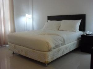 Hotel The Ramelau bedroom with king bed and twin bedside floor lamps