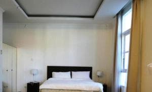 Hotel The Ramelau room with high ceilings, king bed and tall window