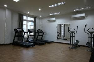 Hotel The Ramelau gym with treadmills and cross-trainers in daylight