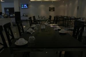 Hotel The Ramelau dining hall with elegant table settings and pendant lamps