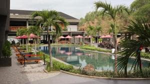 King Room with Balcony — resort pool with palms and red umbrellas
