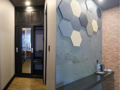 King Room with Pool View — hexagonal feature wall and brick corridor
