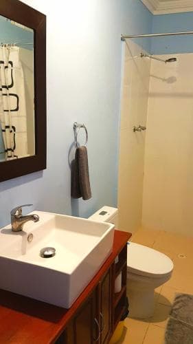 Lauhata Beach Escape bathroom with vanity, mirror and shower