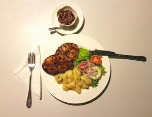 Lauhata Beach Escape grilled chicken plate with potatoes and salad on dinner plate