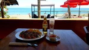 Lauhata Beach Escape oceanview dining with cooked dish and beer at the table