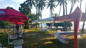 Lauhata Beach Escape beach lawn with red parasols and shade canopies