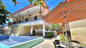 M Y Hotel two-storey building with pool, parasols and arched entrance