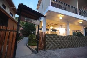 M Y Hotel side entrance walkway with timber gate and porch lights