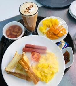 Palm Beach Hotel Dili tall latte by the swimming pool
