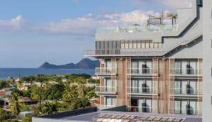 Palm Springs Hotel rooftop view of upper-floor balconies and Atauro island offshore