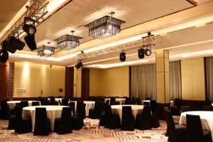 Palm Springs Hotel grand ballroom with banquet round tables and chandeliers