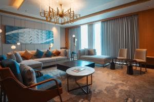 Palm Springs Hotel suite living room with sectional sofa and chandelier