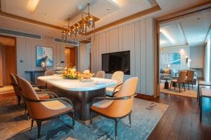 Palm Springs Hotel suite dining room with chandelier and fruit centrepiece