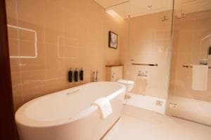 Palm Springs Hotel suite bathroom with freestanding tub and walk-in shower