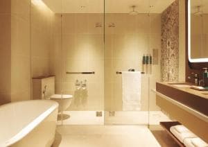 Palm Springs Hotel bathroom with freestanding tub and patterned-tile shower