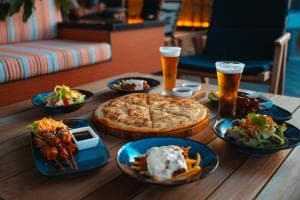Palm Springs Hotel restaurant — sharing platter of small plates and beers