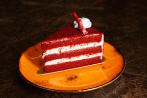 Palm Springs Hotel red velvet cake slice on a yellow plate