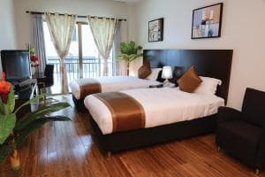 Plaza Hotel Dili studio with king bed, balcony and lounge sofa