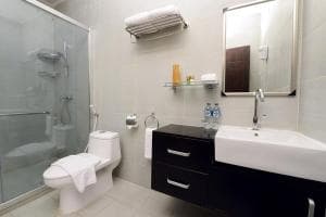 Plaza Hotel Dili bathroom with walk-in shower, single basin and toilet