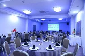 Plaza Hotel Dili conference room with round tables and presentation screen