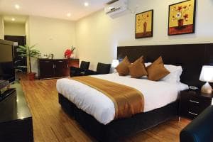 Superior Double Room with king bed and dark wardrobe